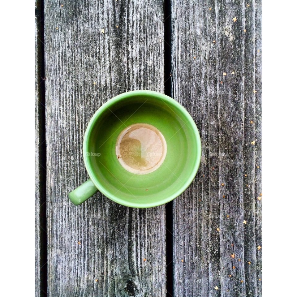 A empty coffee cup on a wooden table
