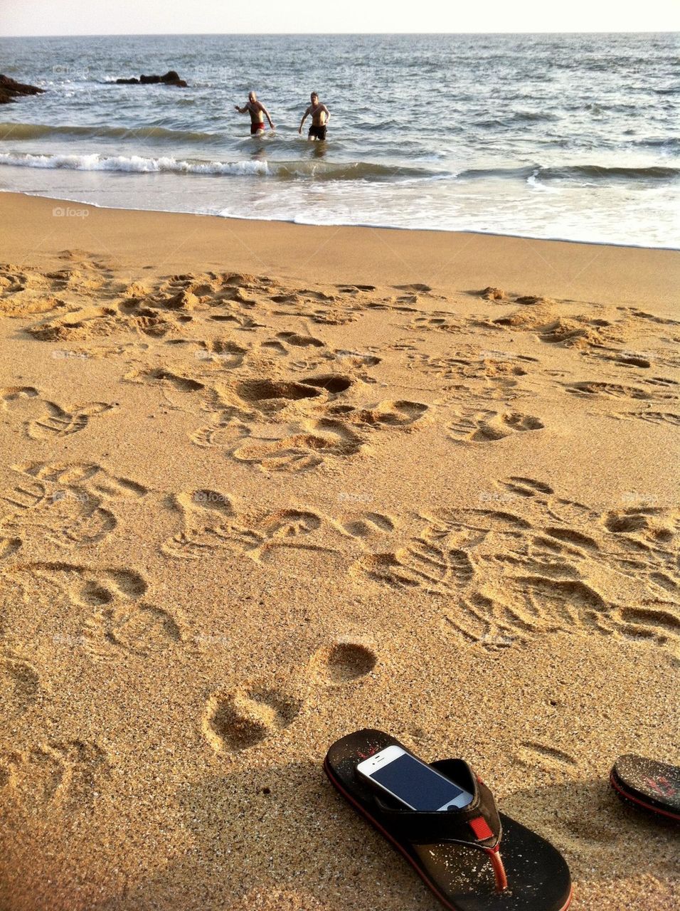 Leave it all behind, flip flops and phone on the deserted beach in Kerala, India