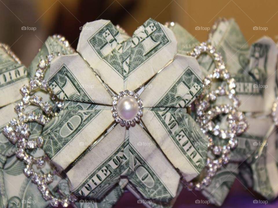 Up close view of the money down, pearl and crystal rhinestone accents
