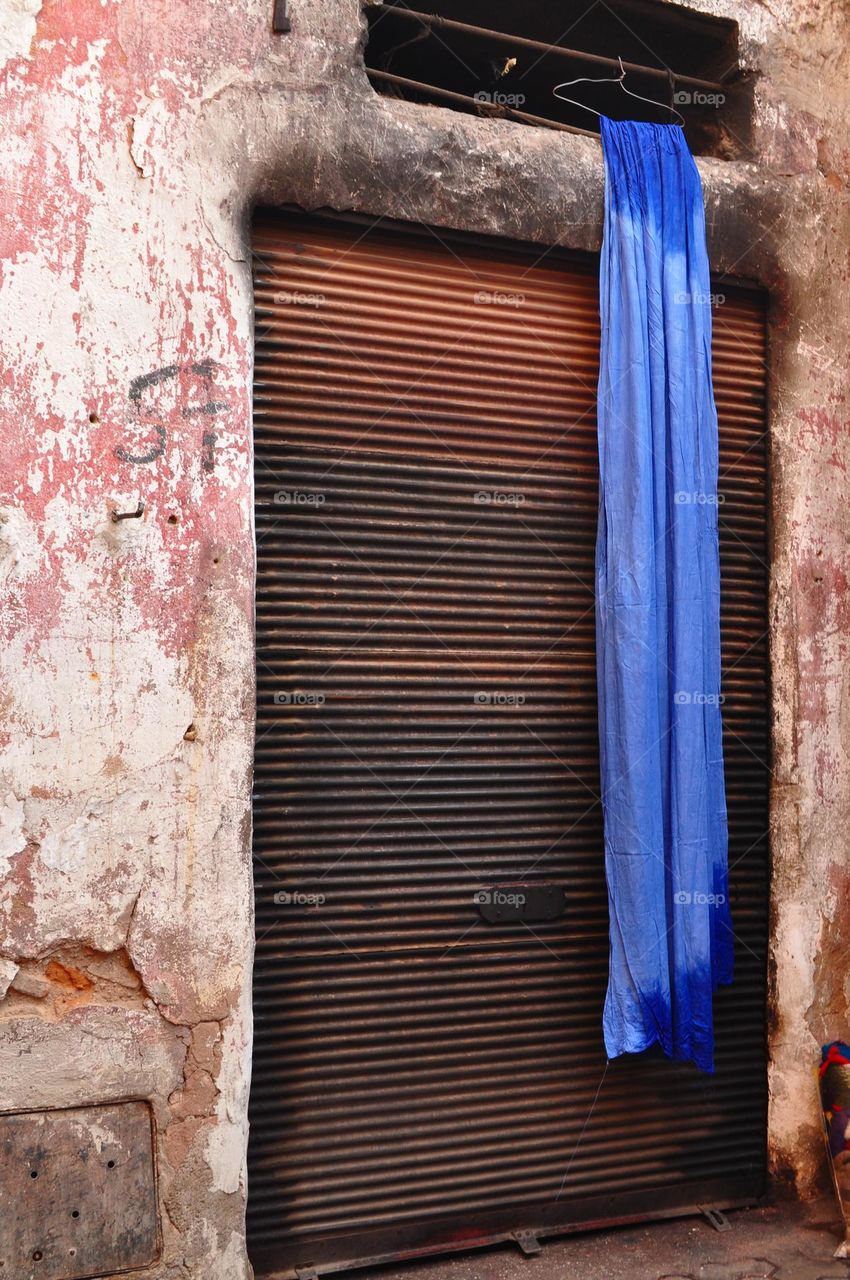 Blue fabric hanging from a window in Marrakech, Morocco 