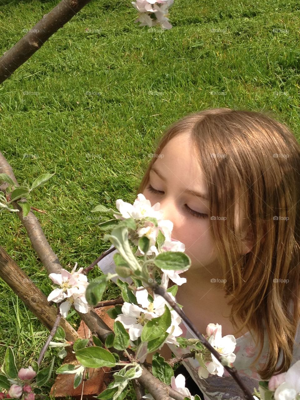 People injouying spring! . The girl smells of spring flowers! 