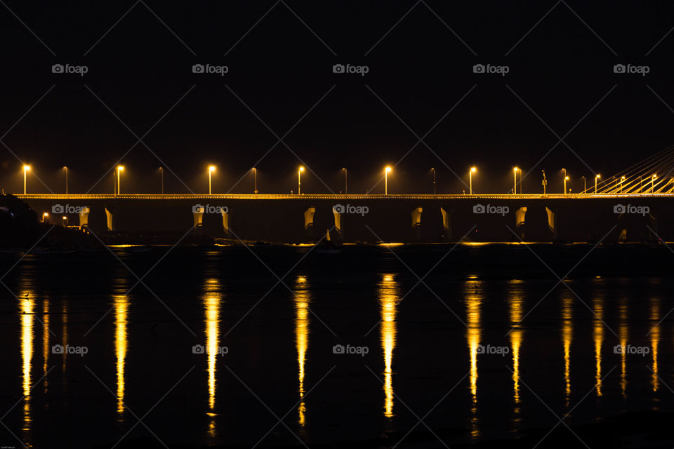 reflection of street lights on the sea link
