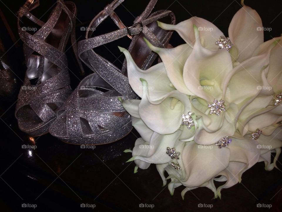 Bride's wedding shoes and bouquet