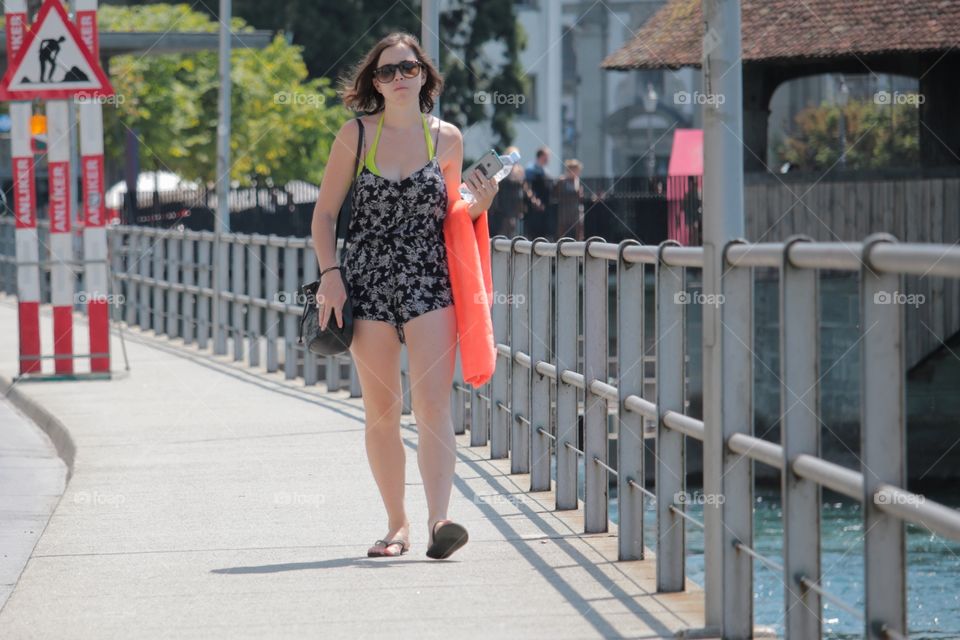 Street Photography. Shot of young girl walking along a bridge in Luzern.