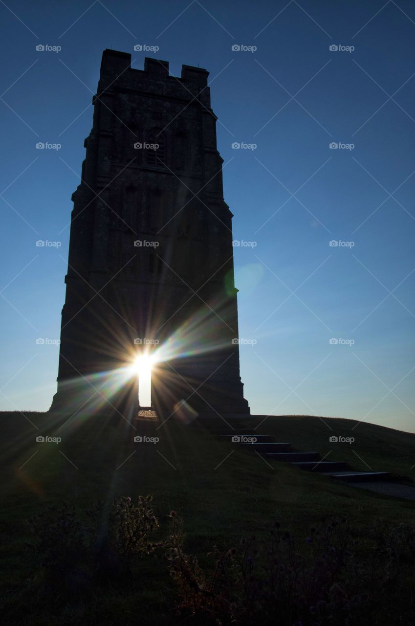 sun rays through the arch of Glastonbury Thor