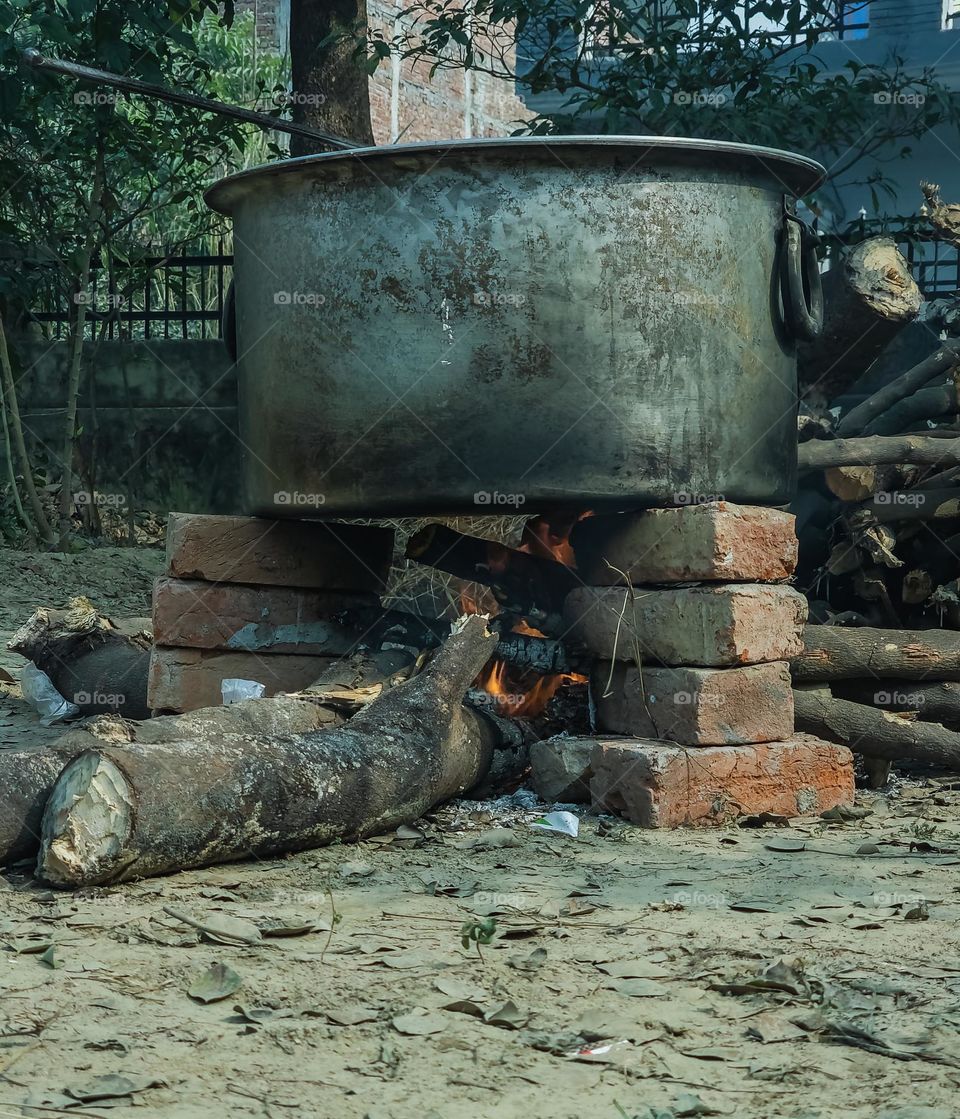 Cooking food by putting woods on fire and man made chulha with Brick gives taste to the food