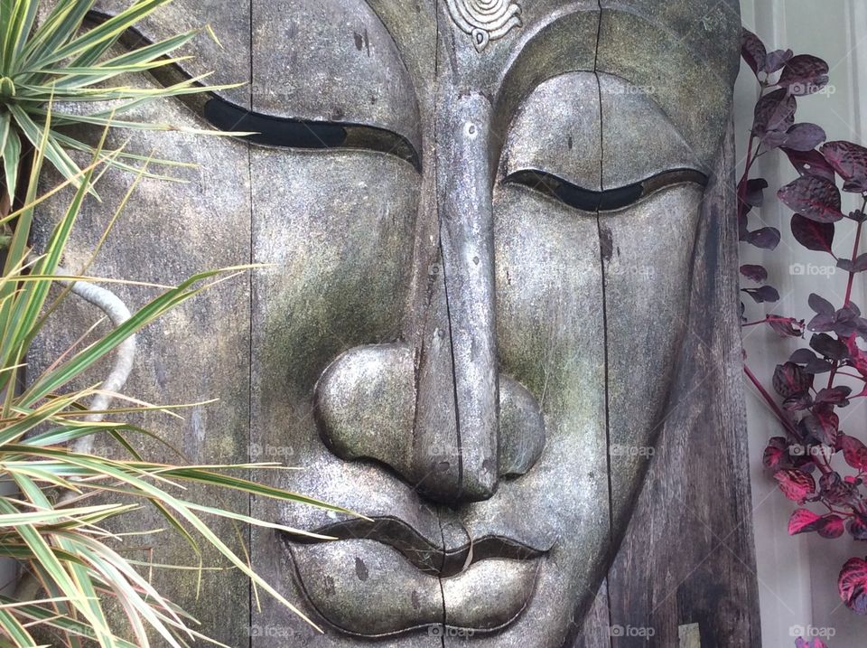 Art from Bali. Large wood carving from Bali in garden setting