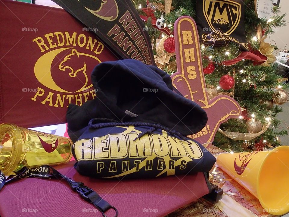 Redmond High School paraphernalia used as decorations at the base of a Christmas tree.