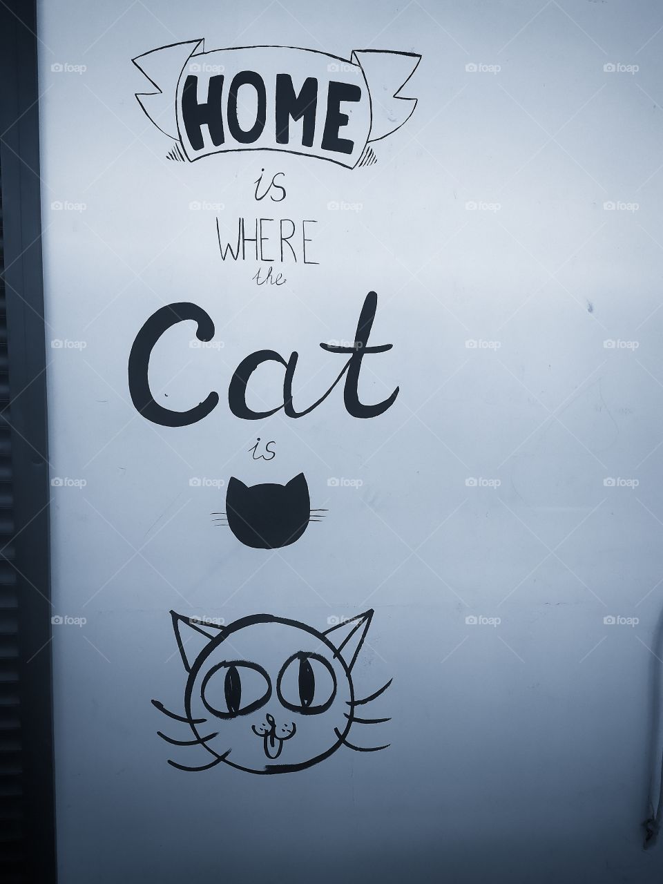 Graffiti.  The inscription "the house where the cat lives" and the drawing of the cat's muzzle