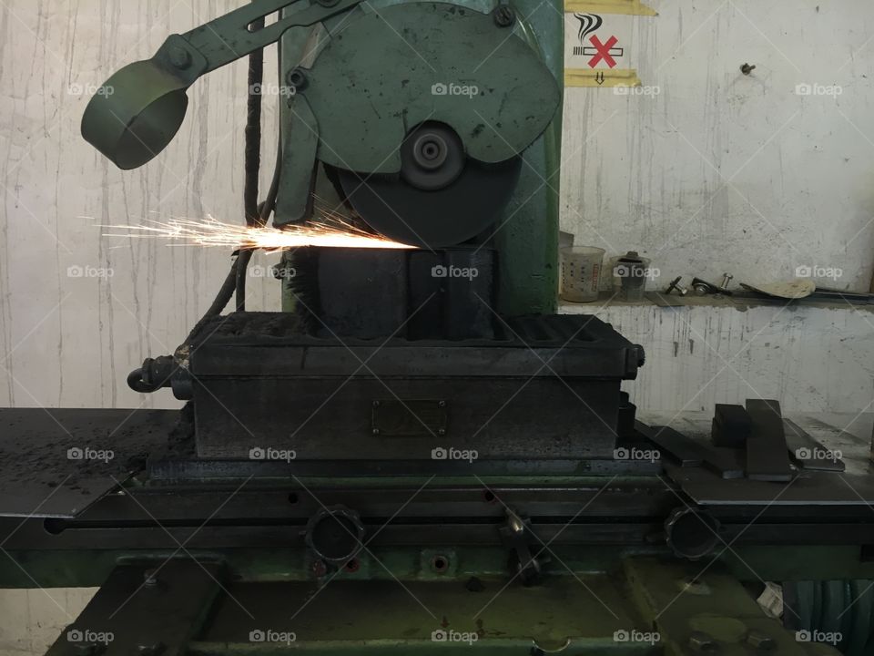 Vintage Industrial machine grinding metal  in old hangar in east Germany. 