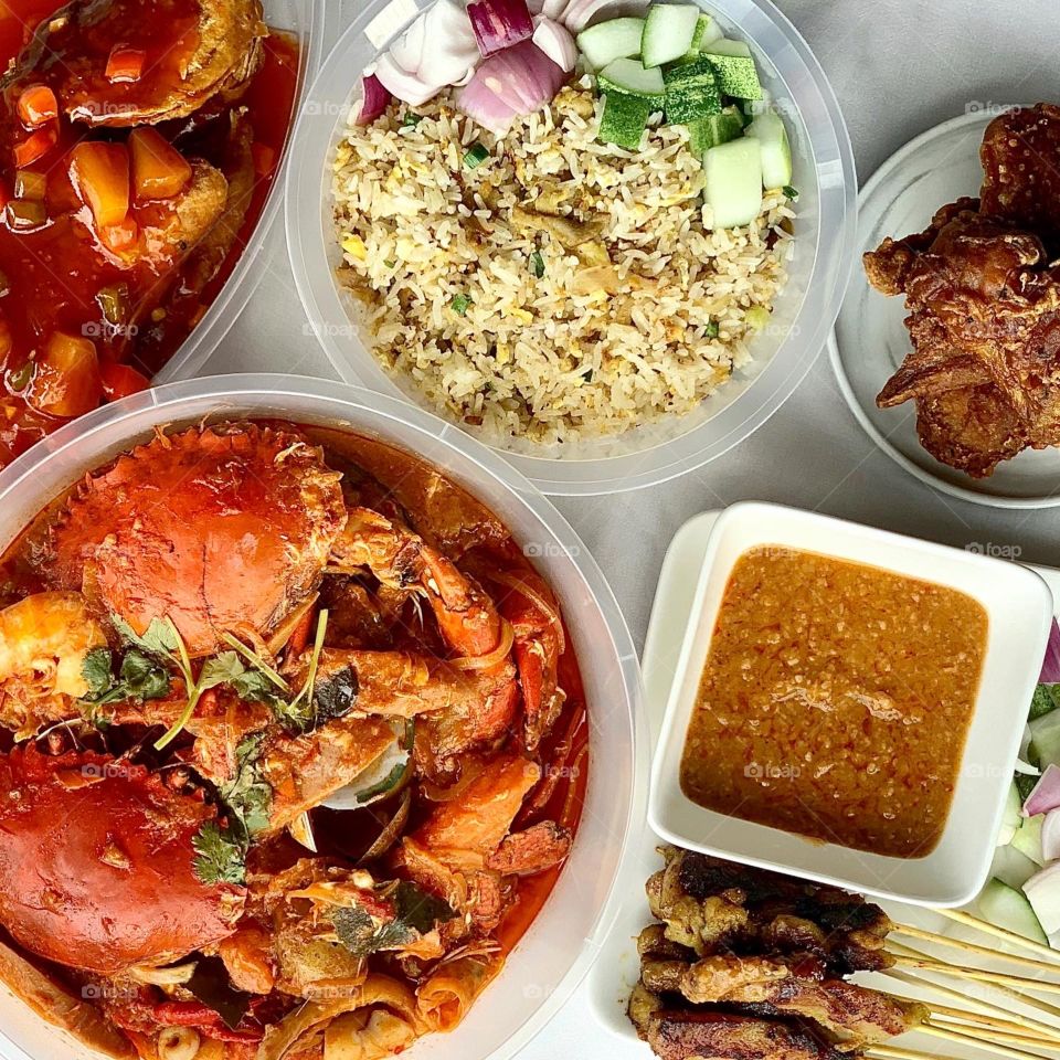 Halal feast consisting of chilli crab shellout, chicken satay fried rice, chicken satay sticks, sweet sour seabass and chicken wings