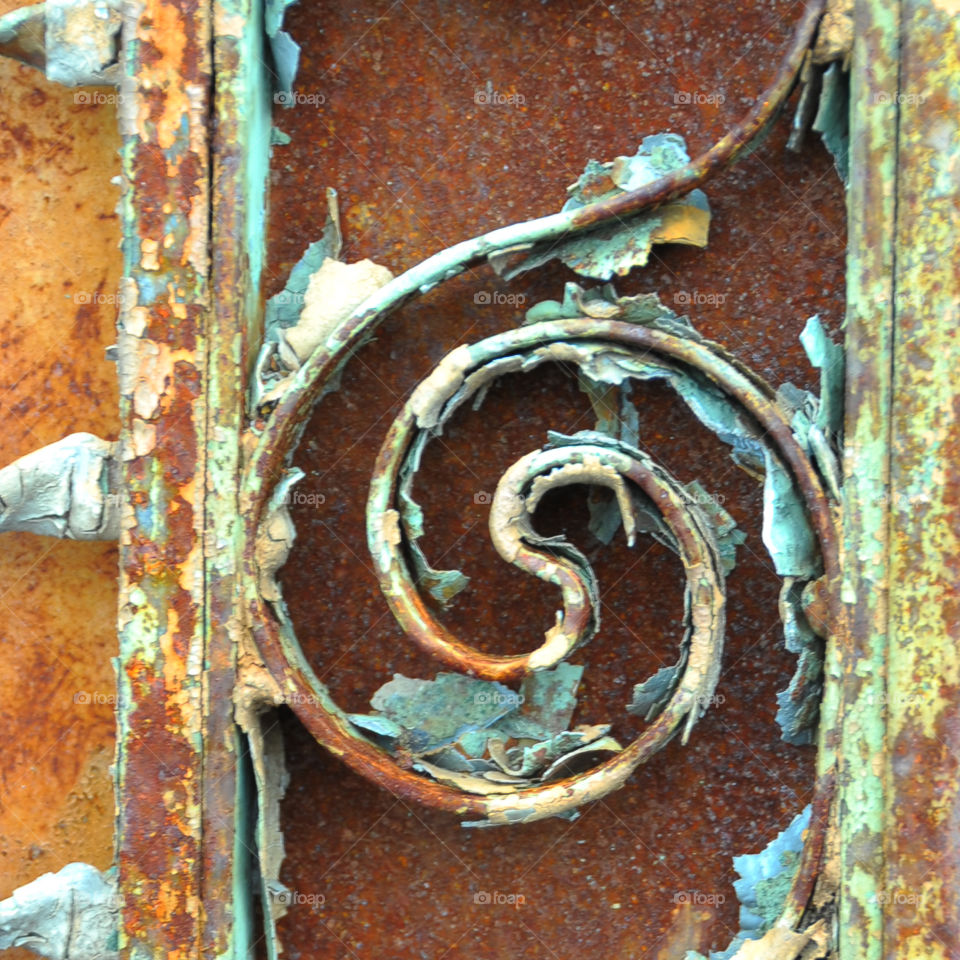 Metal, rusty iron swirl, paint flaking