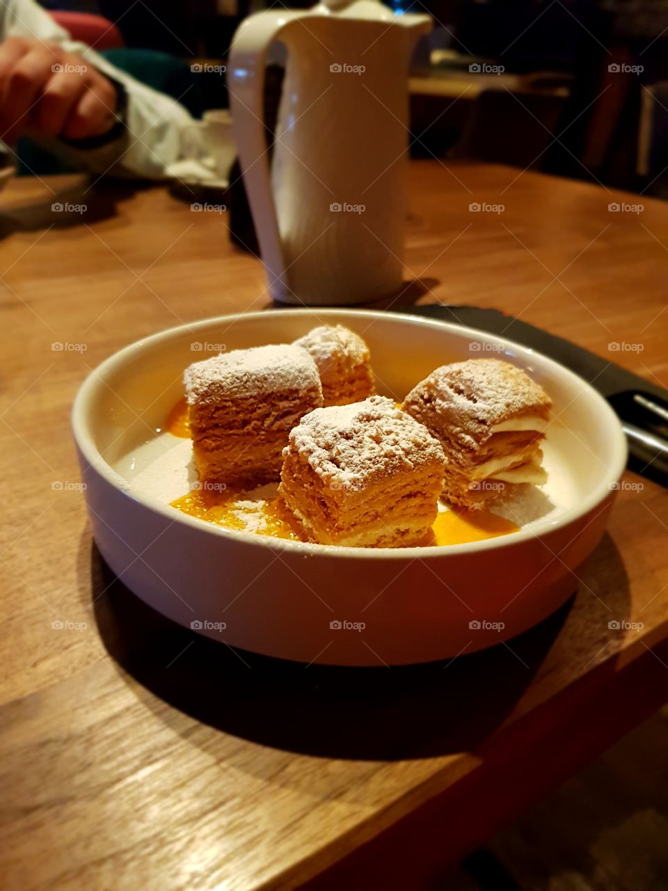 Cake at the table in white plate in cafe