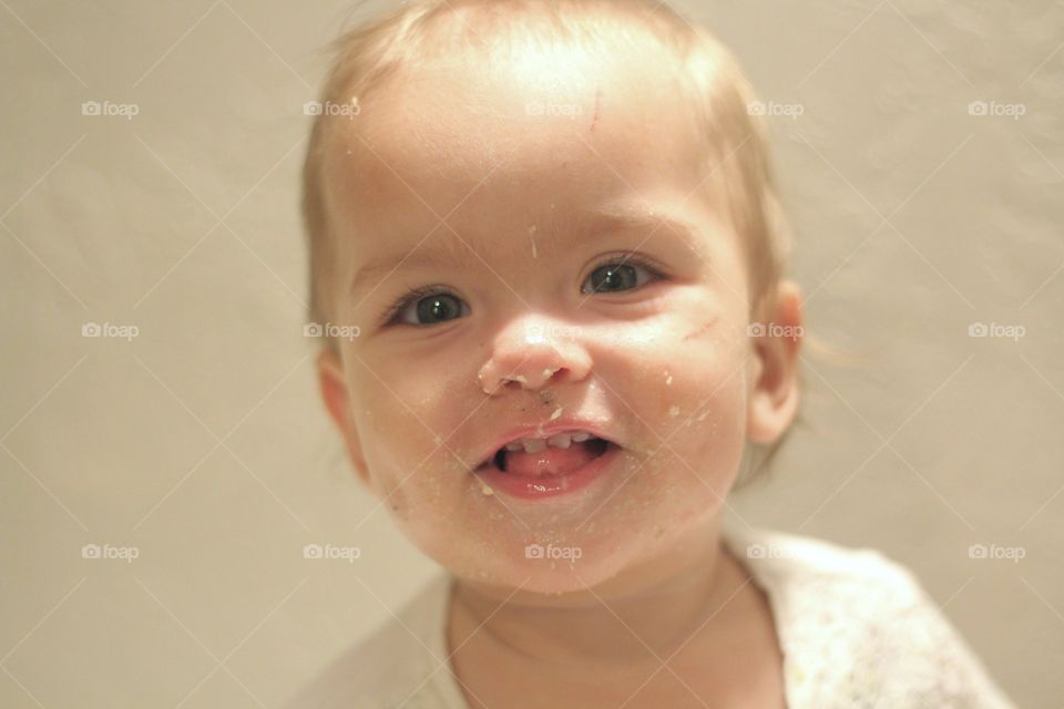 Baby with a Dirty Face Eating Cake