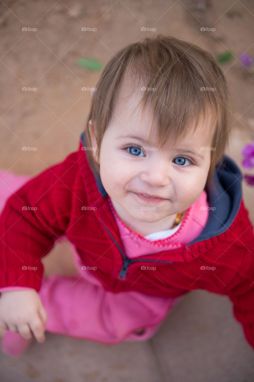 cute baby girl smiling and looking upward