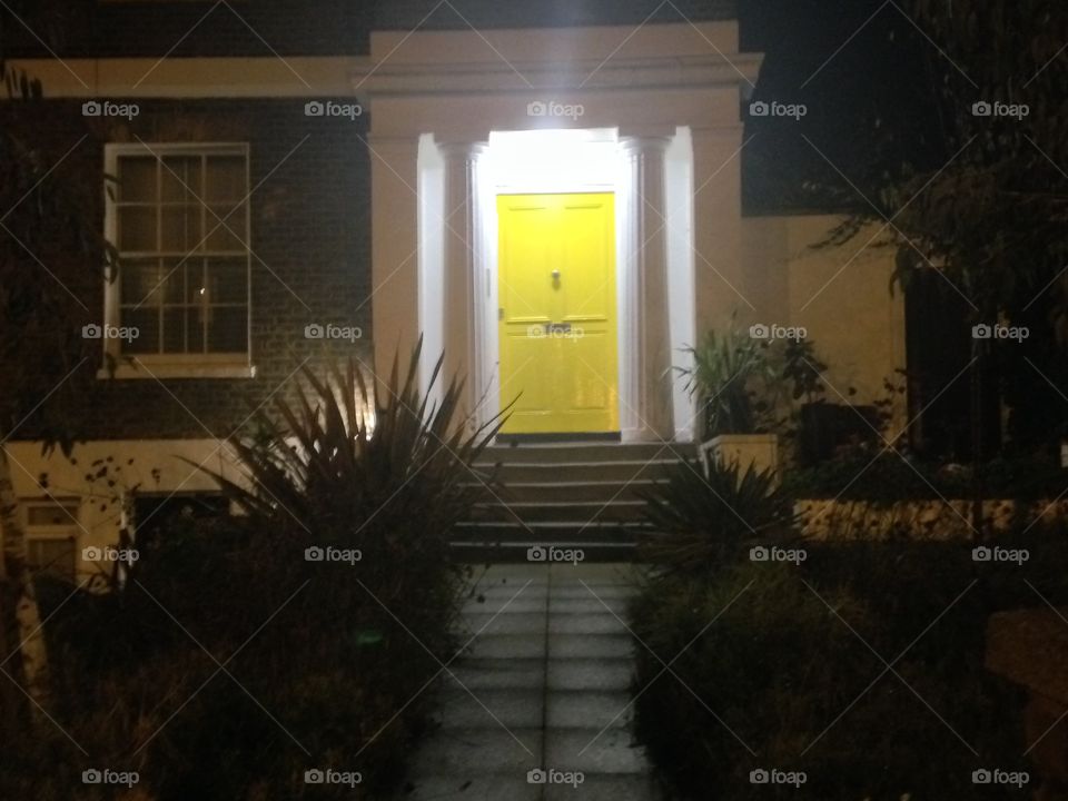 Yellow door. A night scene from around Brixton. London
