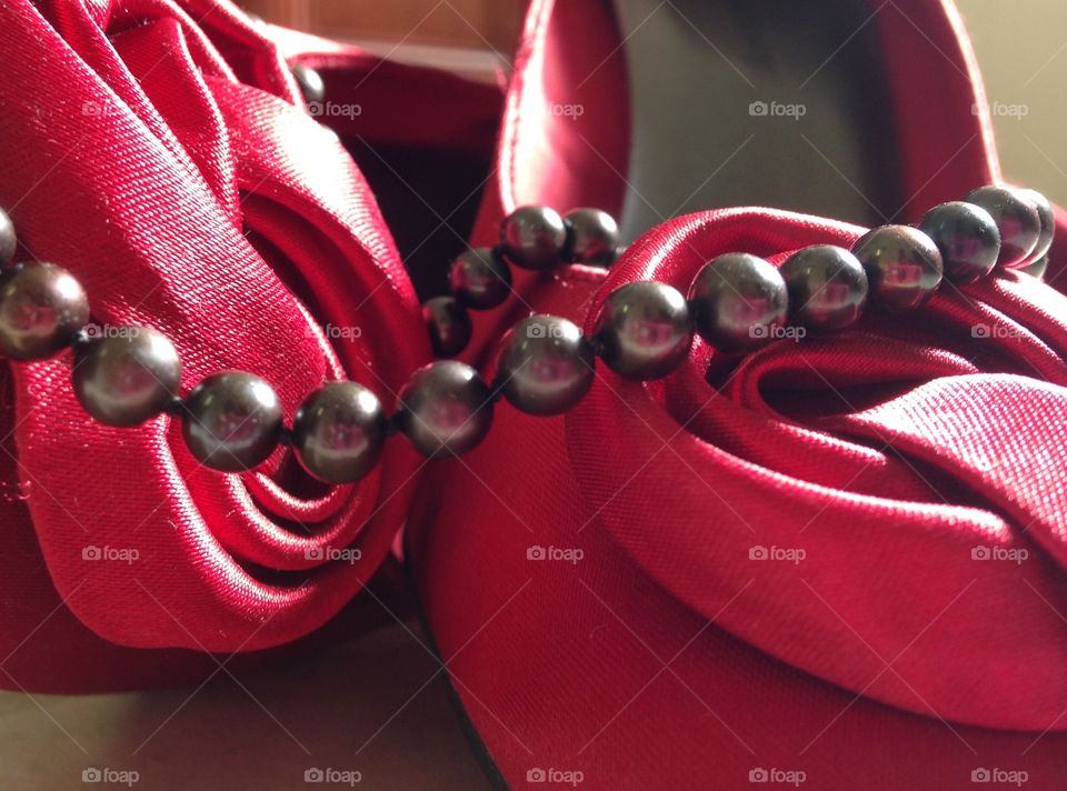 Pearls and heels. Black pearls and red high heels