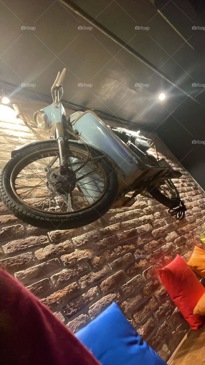 Motorcycle hanging on the wall.