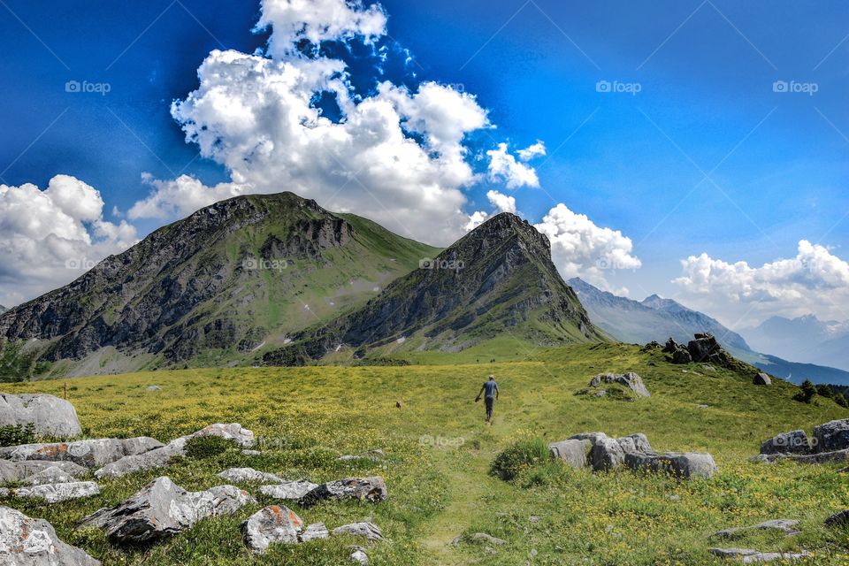 mountain landscape with hiker, swiss alps.