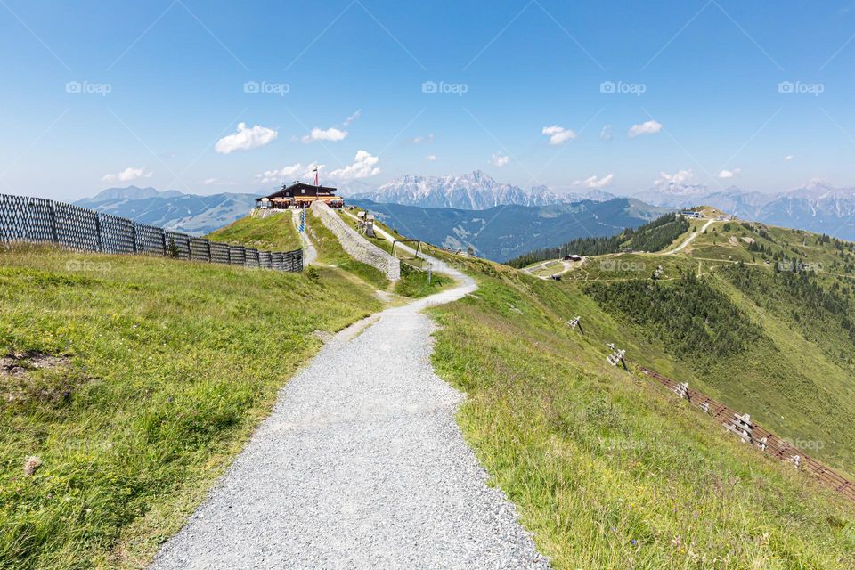 Hiking trail on the mountain Schmitten in the beautiful Alps of Austria on a sunny summer day, stunning view of mountain peaks
