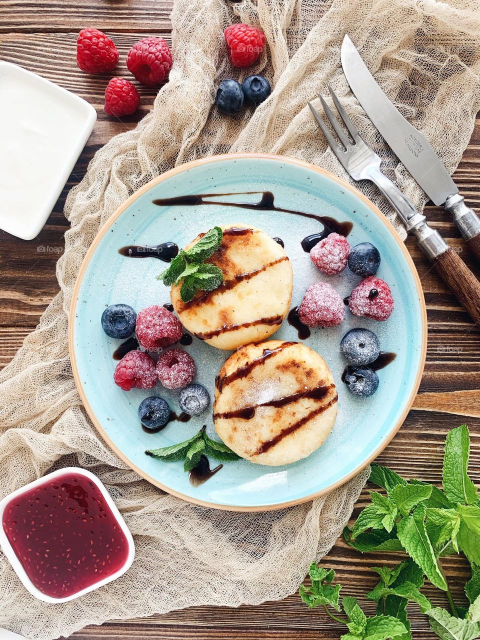 Tasty cheese pancakes on blue plate