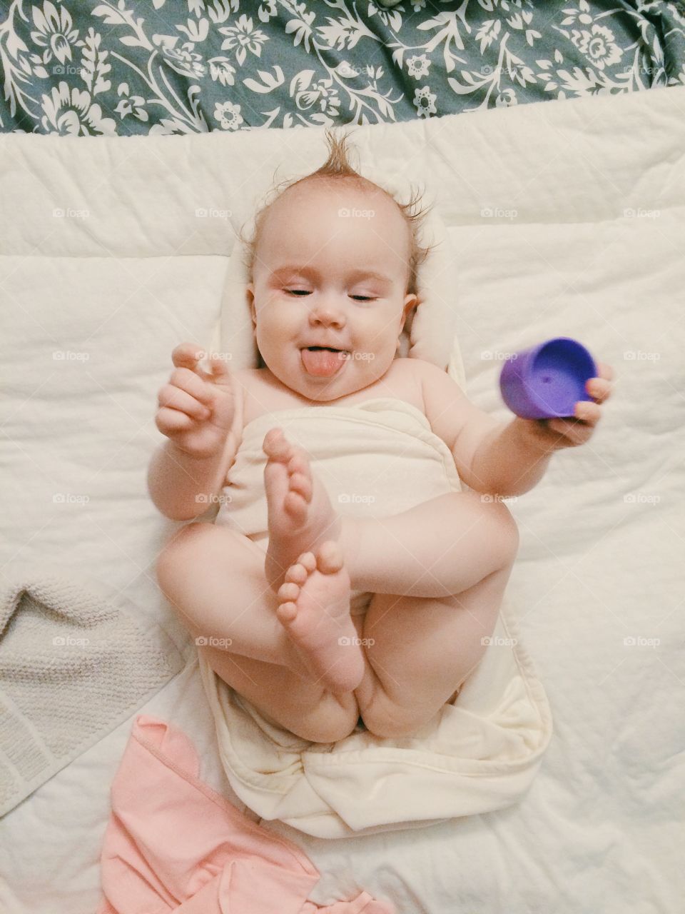 Emotional portrait of cute baby-girl playing with a toy 