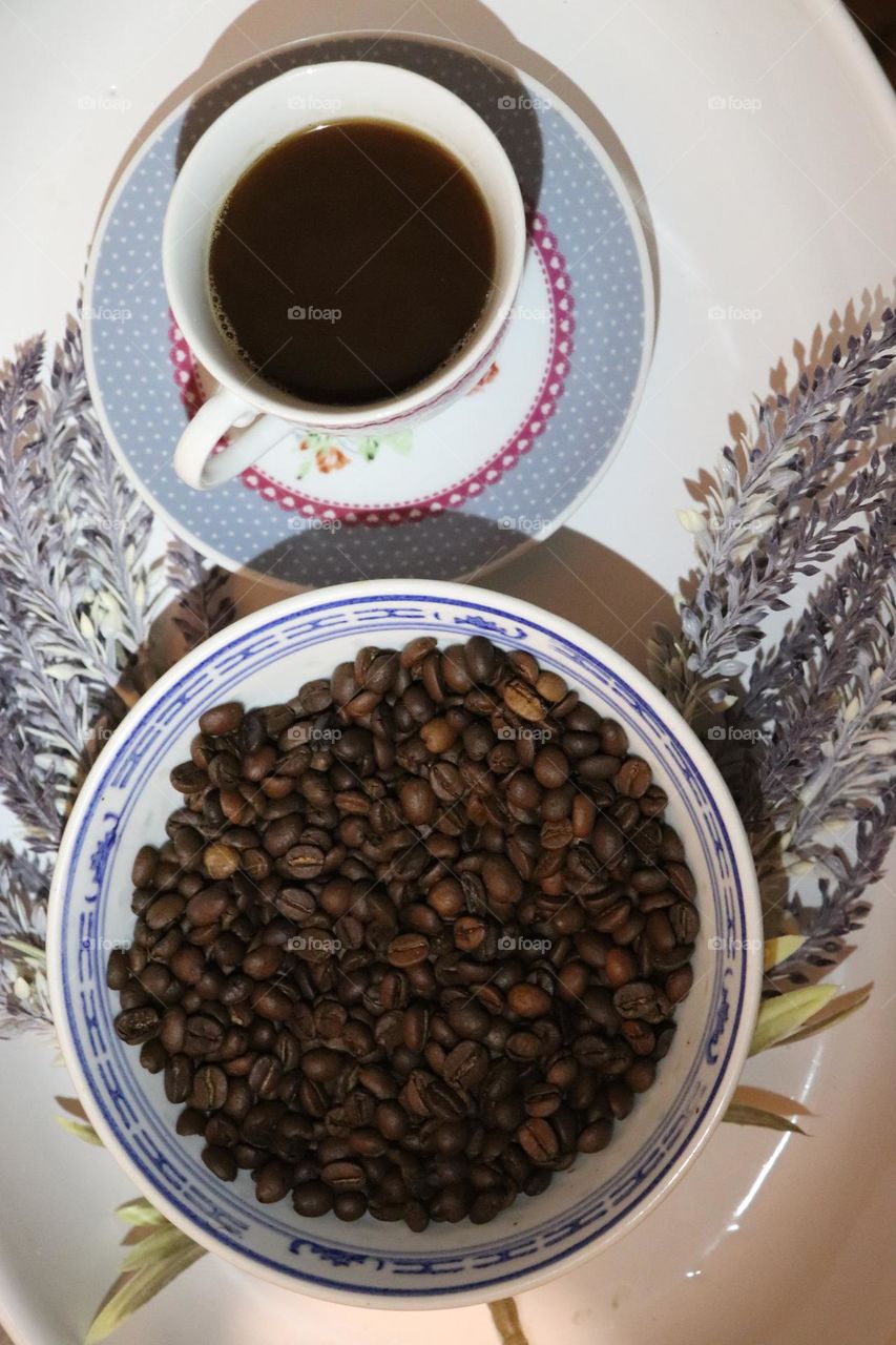 A cup of coffee and coffee beans