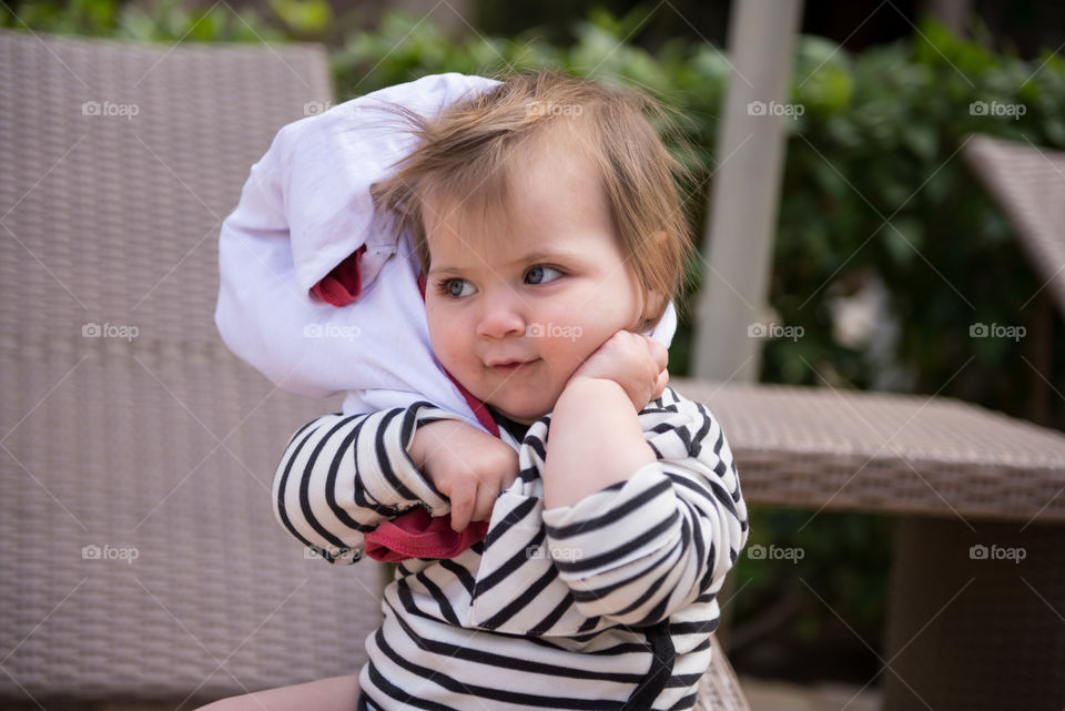 baby trying to put on clothes