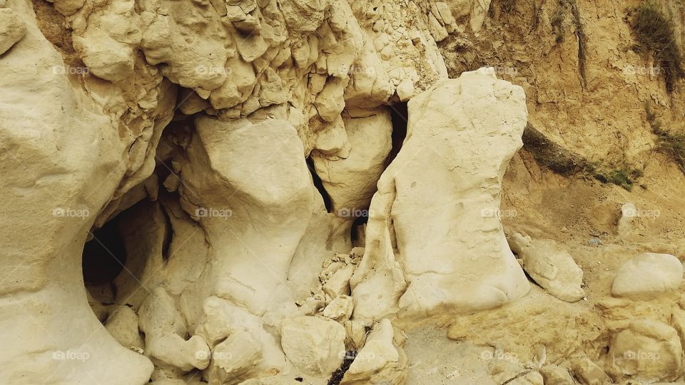 Hole Beach Geological. Erosion has carved strange formations on sandstone on beach.