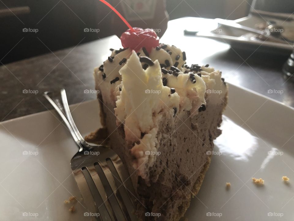 Chocolate pudding pie with cherry on top