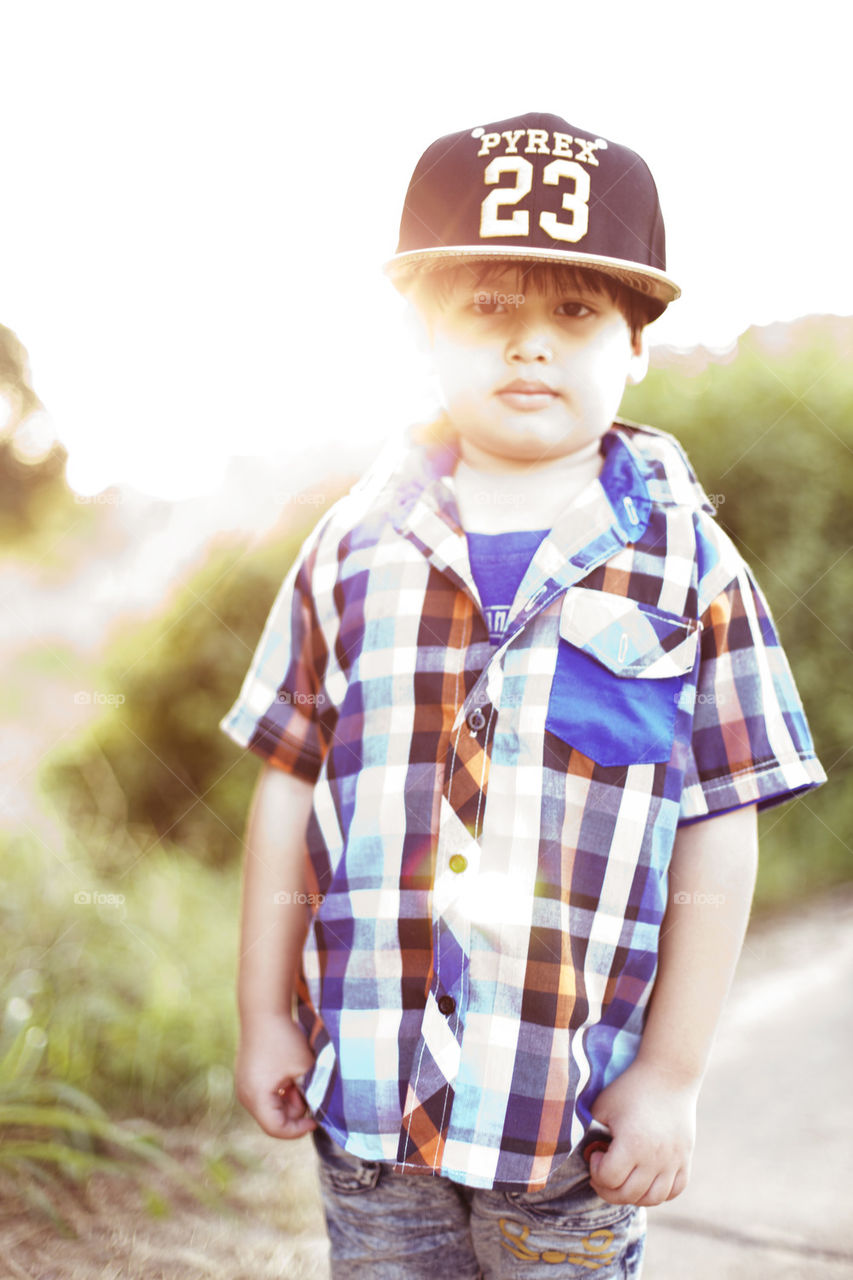 Fashion kid. young boy portrait on a sunny summer day