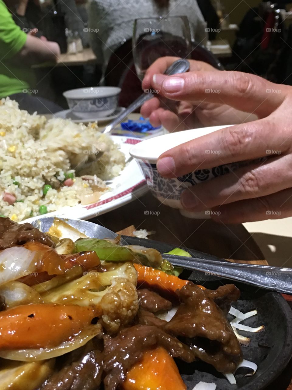 Serving up a bowl of Chinese food, fried rice lemon chicken stir fry closeup person serving self