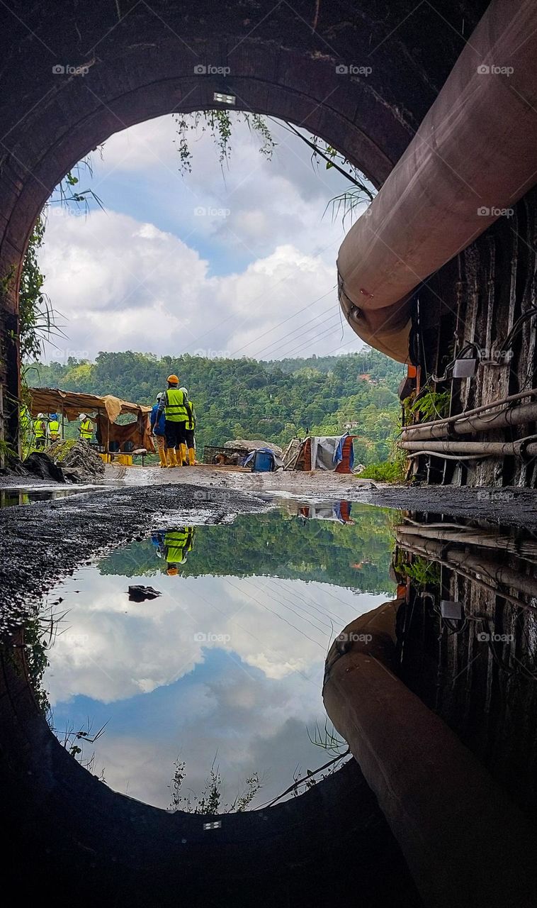 Pond of Transformation: Construction Site Reflected on Calm Waters