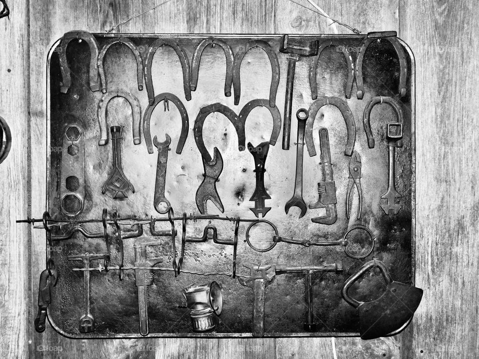 Vintage Vibes: wall full of assorted vintage hand tools used to work on automobiles. Horses were for good luck. 
