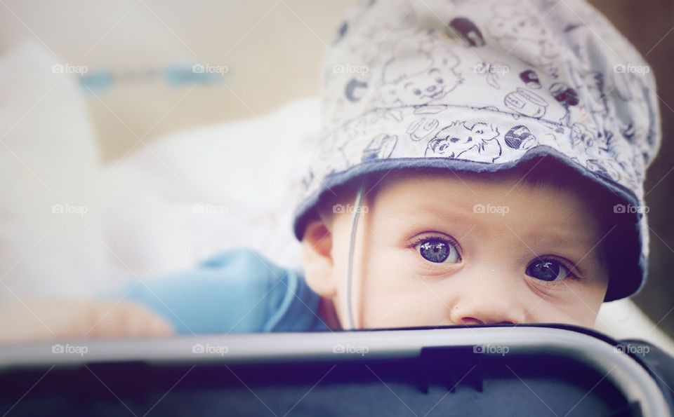 Very cute baby. Baby boy in a stroller