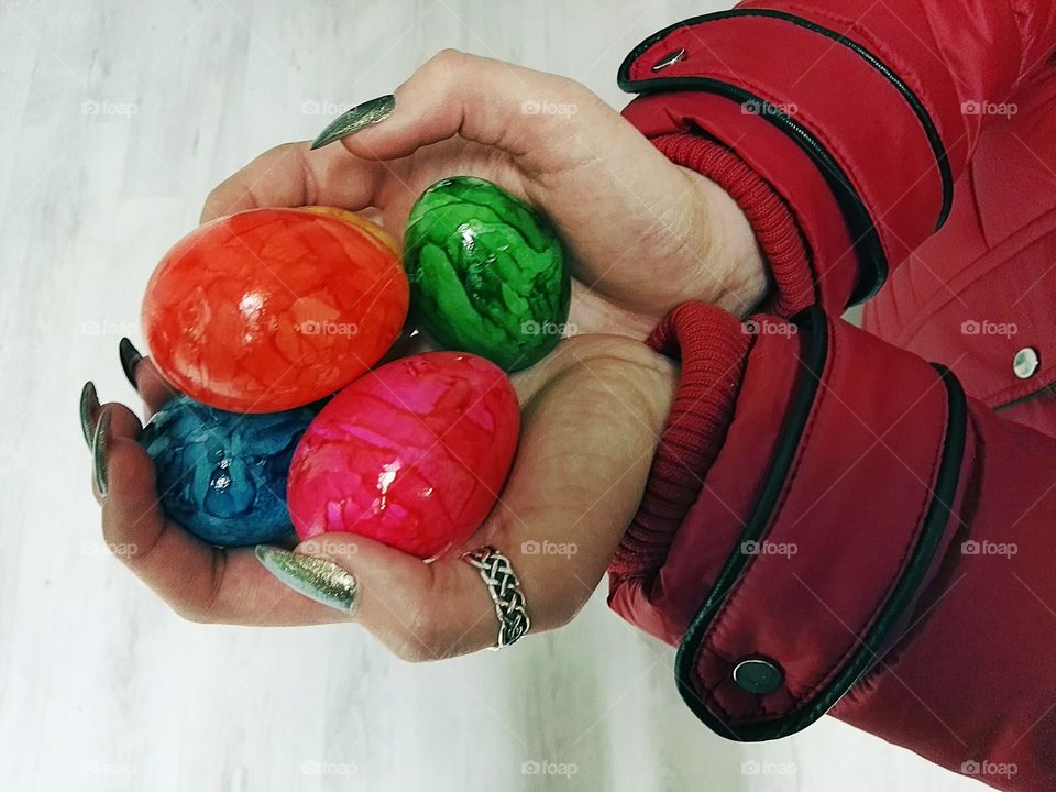 holding colorful easter eggs