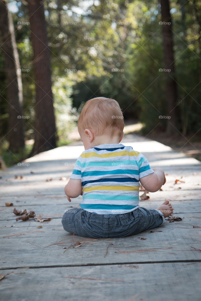 Rear view of a sitting cute baby
