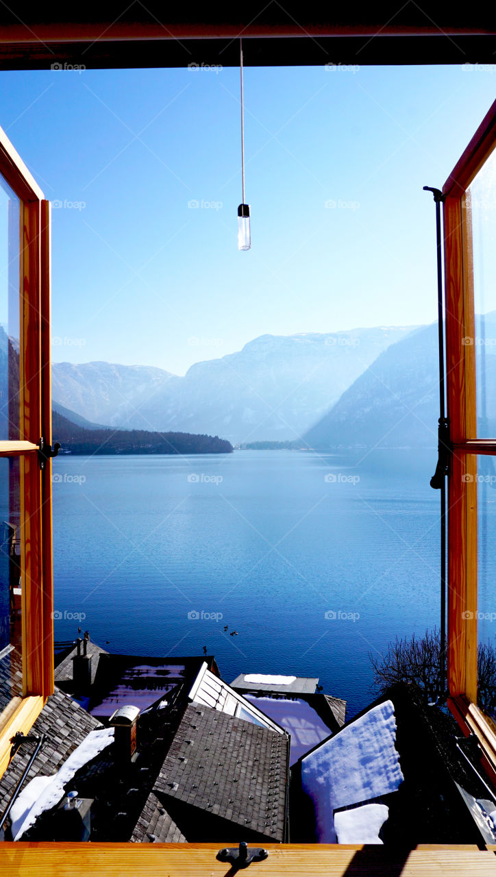 Mountain and lake seen through window in Hallstatt , Austria