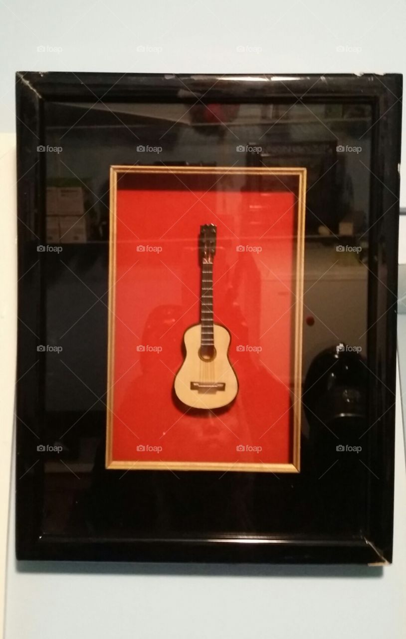 Guitar 
Music Instruments
A Toy Guitar in Red Charming Photo Frame