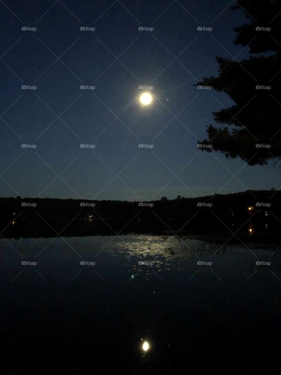 Moonrise over the lake on a calm night.