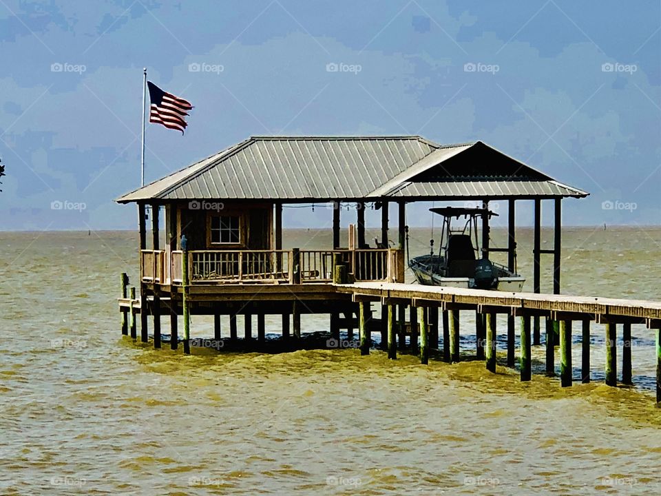 Pier with boat and boardwalk with flag 