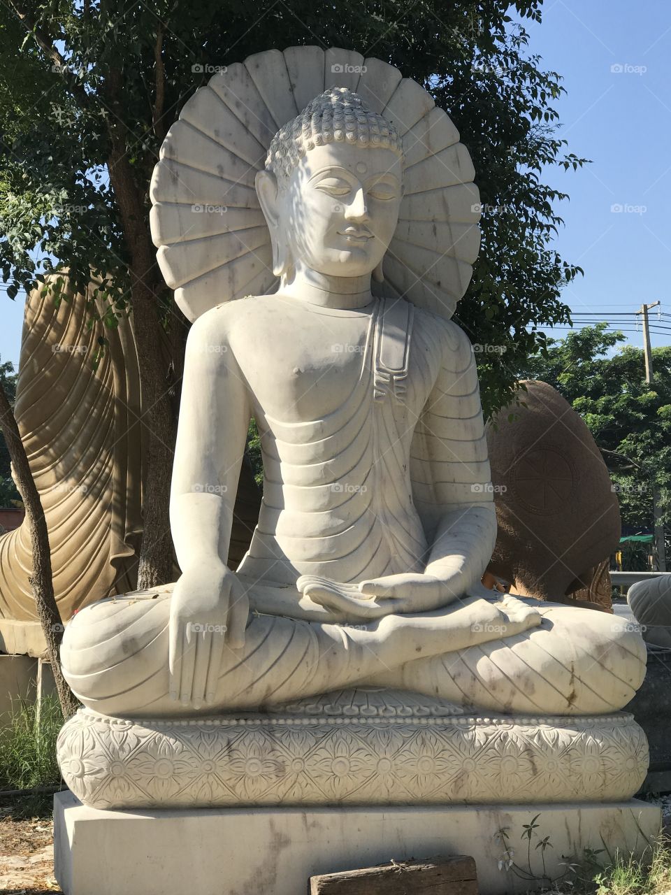 Buddha white stone with sunshine day