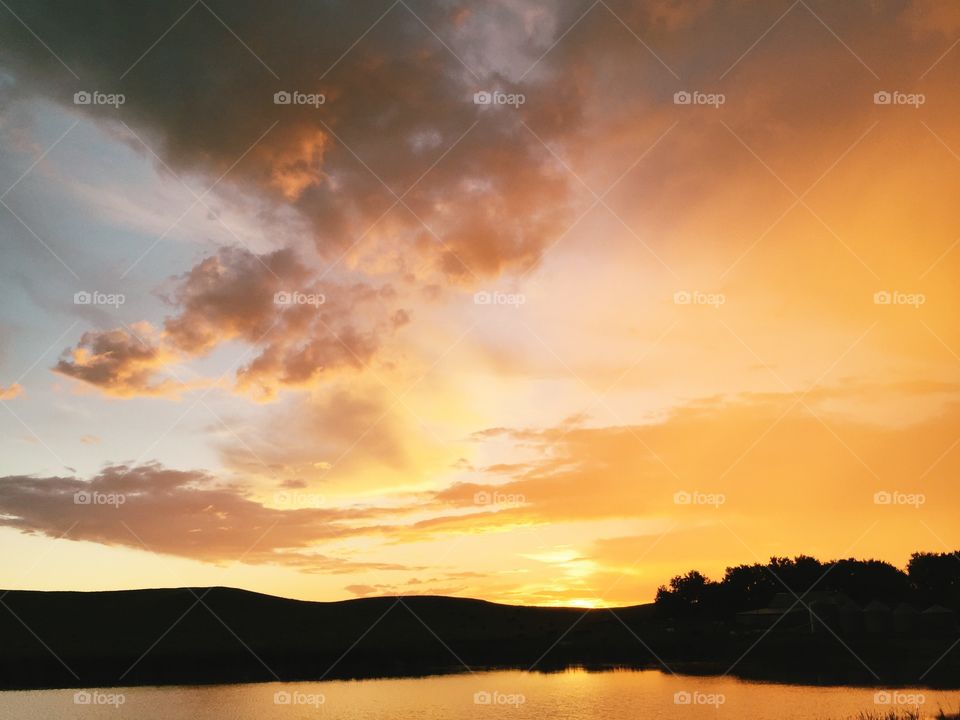 Silhouette of mountain and trees during sunset