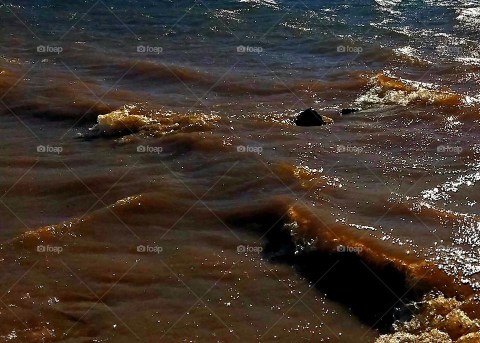 rough water over rock at shore