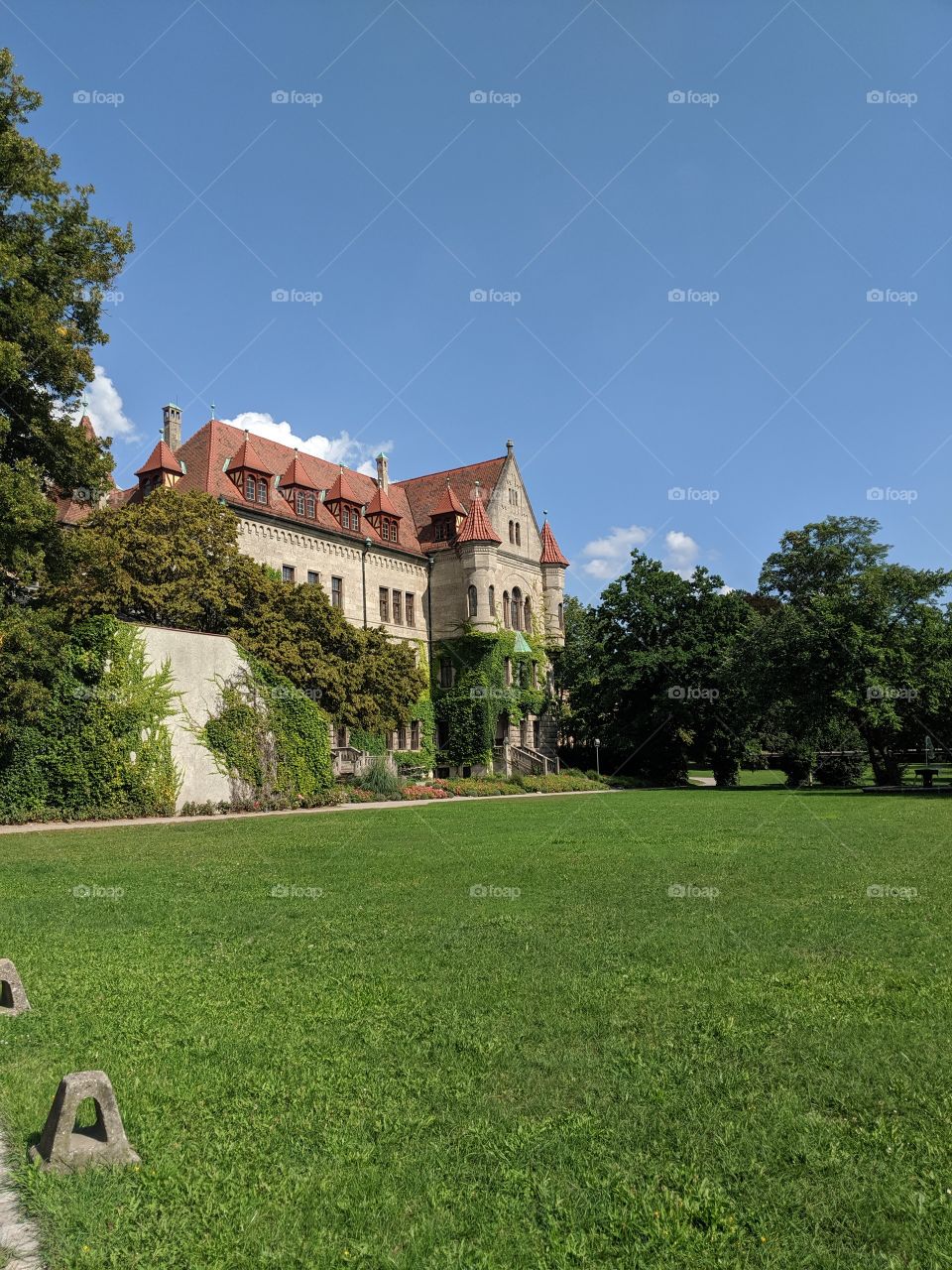 bright sunny old German European castle fascade front lawn park vacation