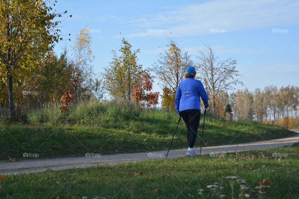 woman sport walking  on a road autumn landscape