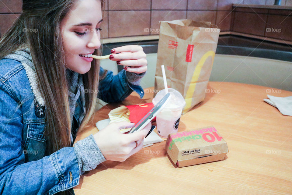 McDonald’s- girl eating at McDonald’s.