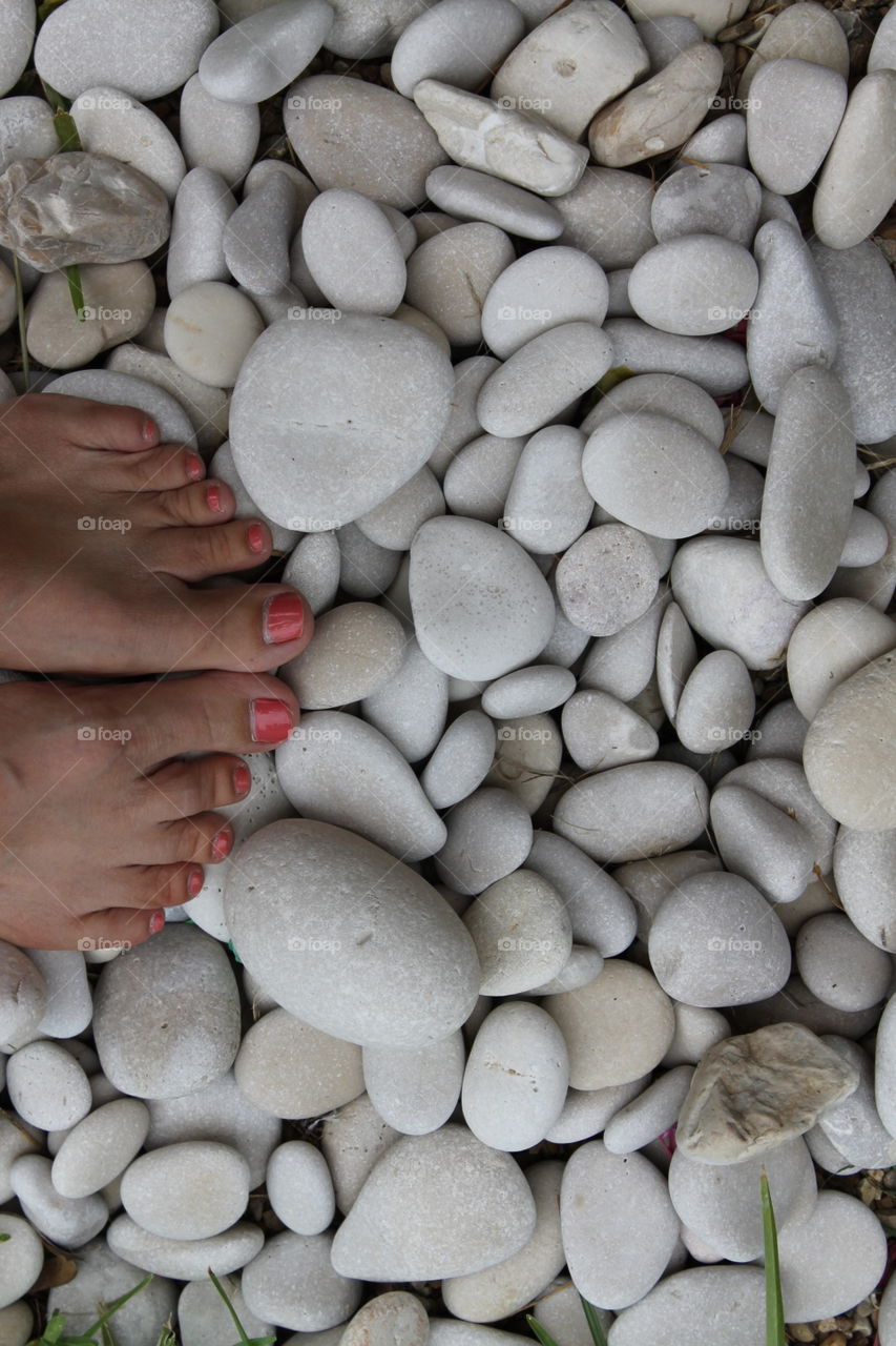 Polished toes on white round stones