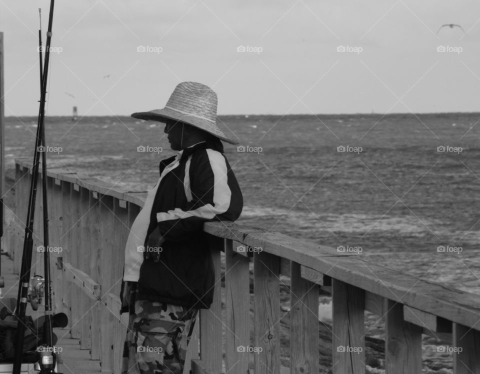 While snapping pictures in Surfside Beach Texas I noticed this man taking a break from his days work. 
