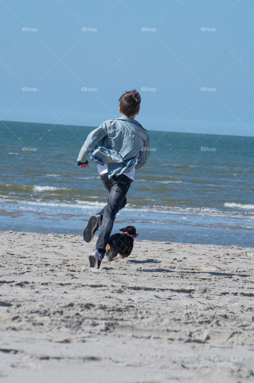 Running with the dog on the beach